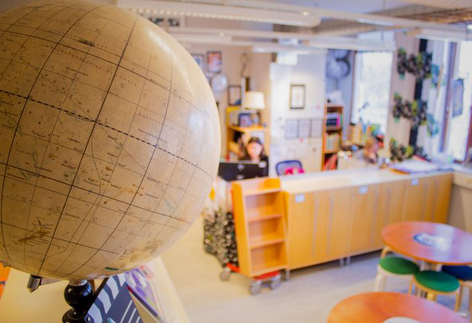 Jordglob på bokhylla i skolbibliotek. 